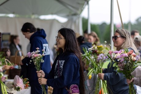 A group of people holding flowers