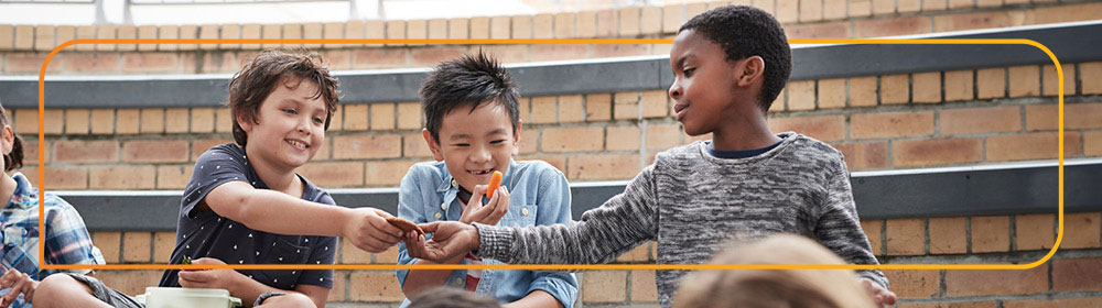 child passing a cookie to another child